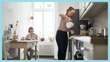 Carer makes cup of tea in kitchen