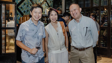 Three Vlog alumni smiling to the camera at the Singapore alumni event.