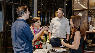 Vlog alumni chatting at the Singapore alumni event.