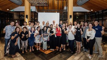 Vlog alumni smiling at the camera at the Singapore alumni event.