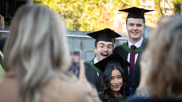 Happy graduates posing for a photo