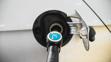 A close up of a fuel pump connected to a car