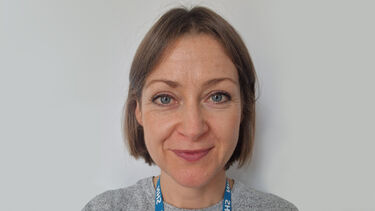 A head and shoulders photo of a woman with short, light brown hair.