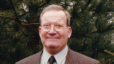 Professor Michael F Lynch standing outdoors in a suit