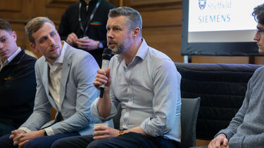 Image of Dave Moss sat with a microphone 