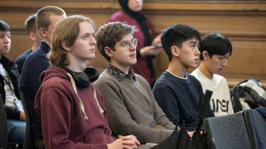 Image of students sat watching a presentation in Mappin Hall 