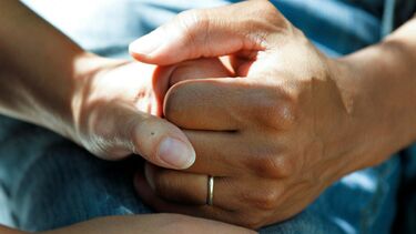 Close-up of two people holding each others' hand