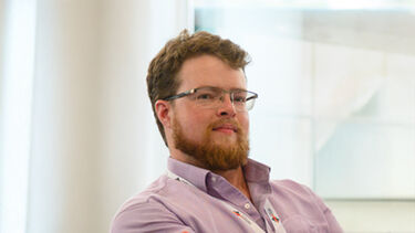 Headshot of Sam Yeates (white male with facial hair)