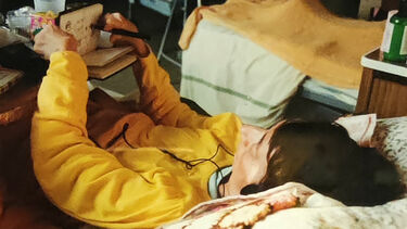 Photo of Nerys Johnson sketching from her bed