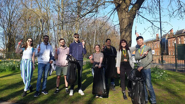 A group of people litter picking in Crookes Valley Park