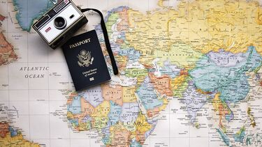 A world map with a camera with passaport