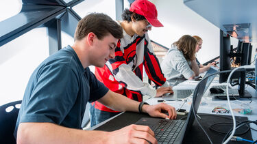 2 student coding in lab