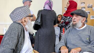 A group of mixed ethnic elderly people talking 