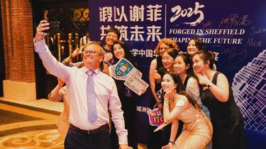 Dr Malcolm Butler, VP and Director of Global Engagement, taking photo with Sheffield alumni. 