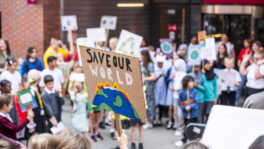Children with climate placards