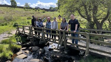 Students pose for a photo on a bridge at Padley Gorge in the Peak District