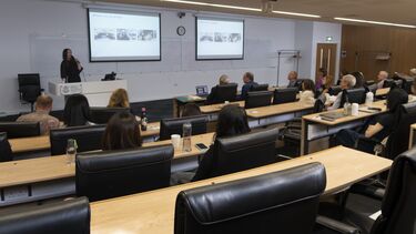 Nicola Lawrence-Thomas speaking to a busy lecture theatre.