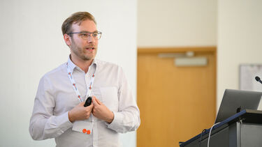 White male with blond/brown hair presenting a talk