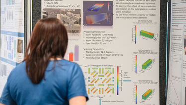 Person viewing a scientific poster
