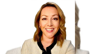 A headshot of Danielle Clarke smiling against a white background