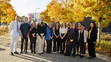 Members of the SMART-Health team pose in front of autumnal trees.