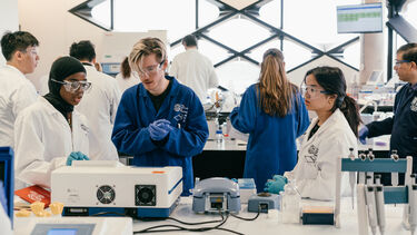 Students working in a lab environment with a demonstrator supervising