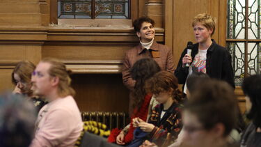 A participant asks a question at the Drag and the Law event