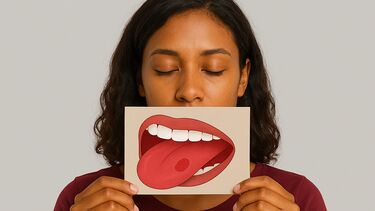 A woman with her eyes closed holding a picture of a mouth with the tongue sticking out.
