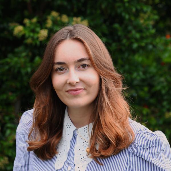 Profile picture of Nicola Thomas wearing a blue and white striped top.