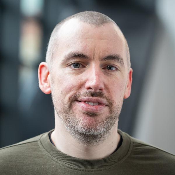 Profile picture of A headshot of Adam Brown, who is half smiling