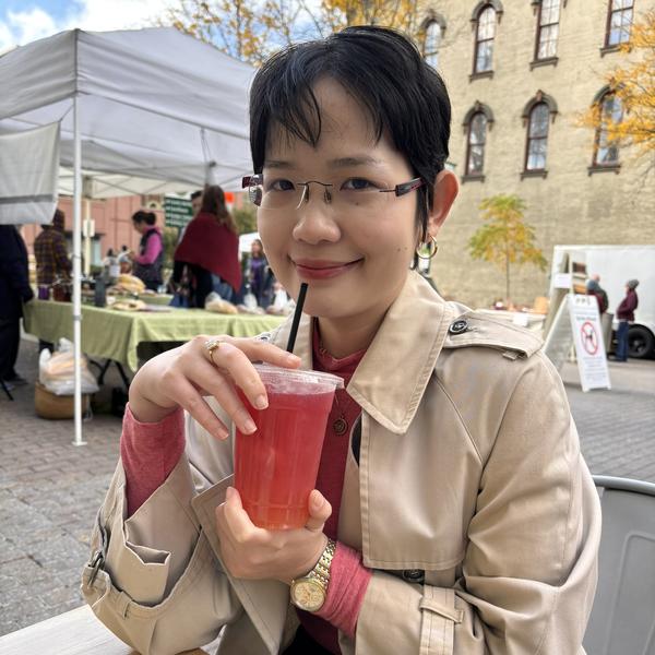 Profile picture of Penelope Gia Bao Huu Nguyen in a pretty town with a drink