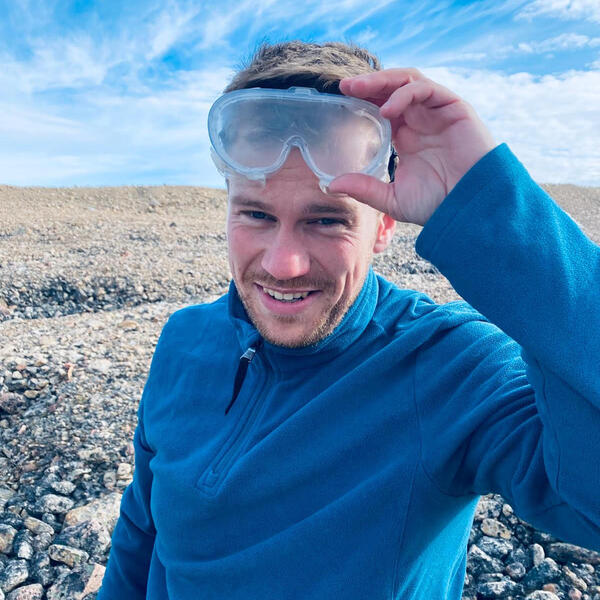 Profile picture of Jeremy Ely holding a pair of plastic safety goggles on his forehead