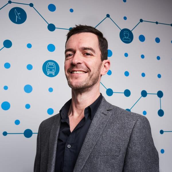 Profile picture of An image of Robert Langley in a suit stood in front of a graphical background.
