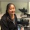 Ge Zhang working with a microscope in the lab