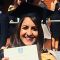 Sonia Nayyar in her graduation gown holding her degree certificate