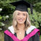 A woman in a graduation cap and gown