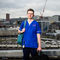 Elliot wearing blue scrubs, Sheffield skyline in background