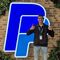 Student, thumbs up, standing in front of the PayPal logo