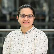 Researcher wearing spotted shirt and glasses
