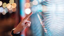 Woman pointing to a digital screen