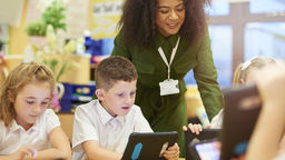 Children and teacher using digital media in the classroom