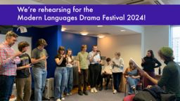 A dozen students in a light room, looking at their phones to read the script for their theatre rehearsal
