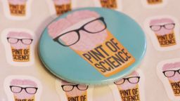 pint of sicence badge laid on top of pint of science stickers