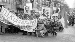 An image of a group of communist protestors with flags and picket signs, holding a demonstration