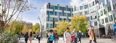 People walking past the Jessop West building on the University of Sheffield's campus 