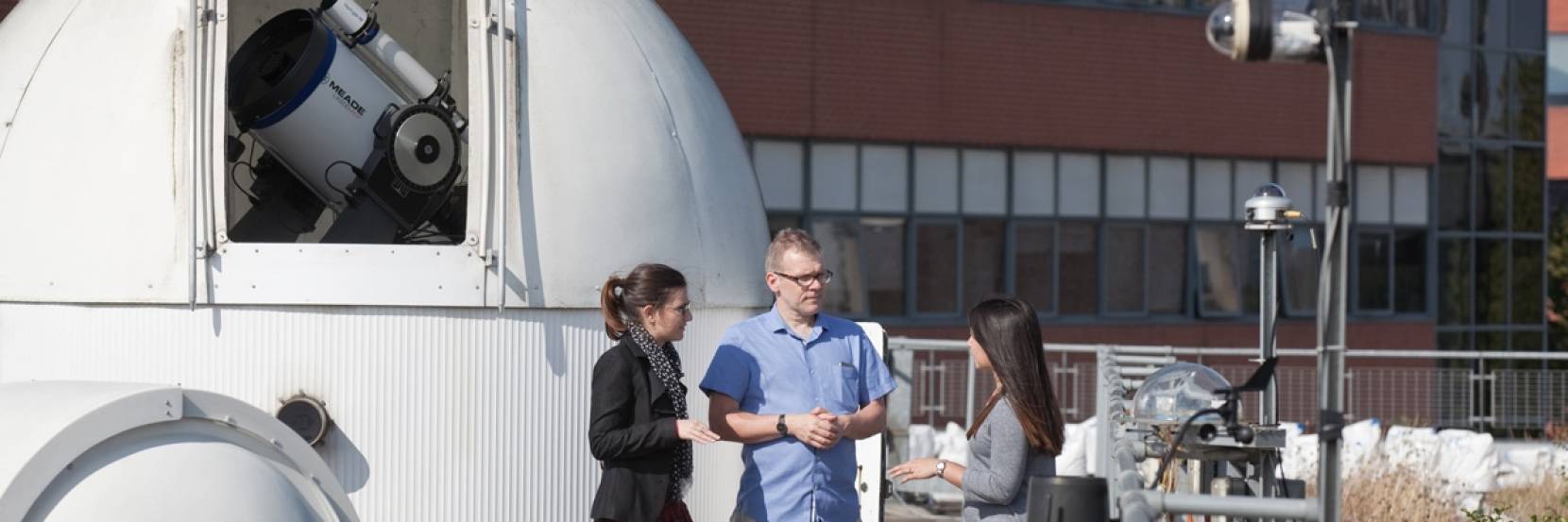 Students with the University of Sheffield's rooftop telescopes