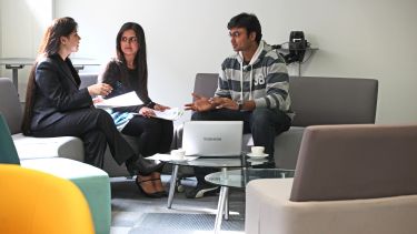 Three Computer Science postgraduates at table