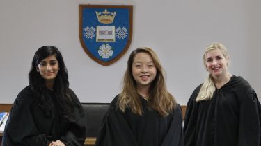 Three law students take part in mooting.