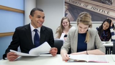 Law students dressed smartly and laughing in class