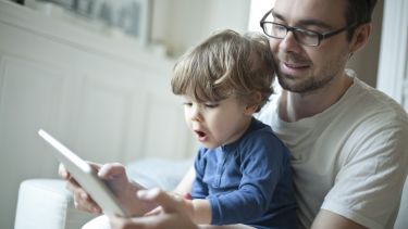 parent and child using tablet together
